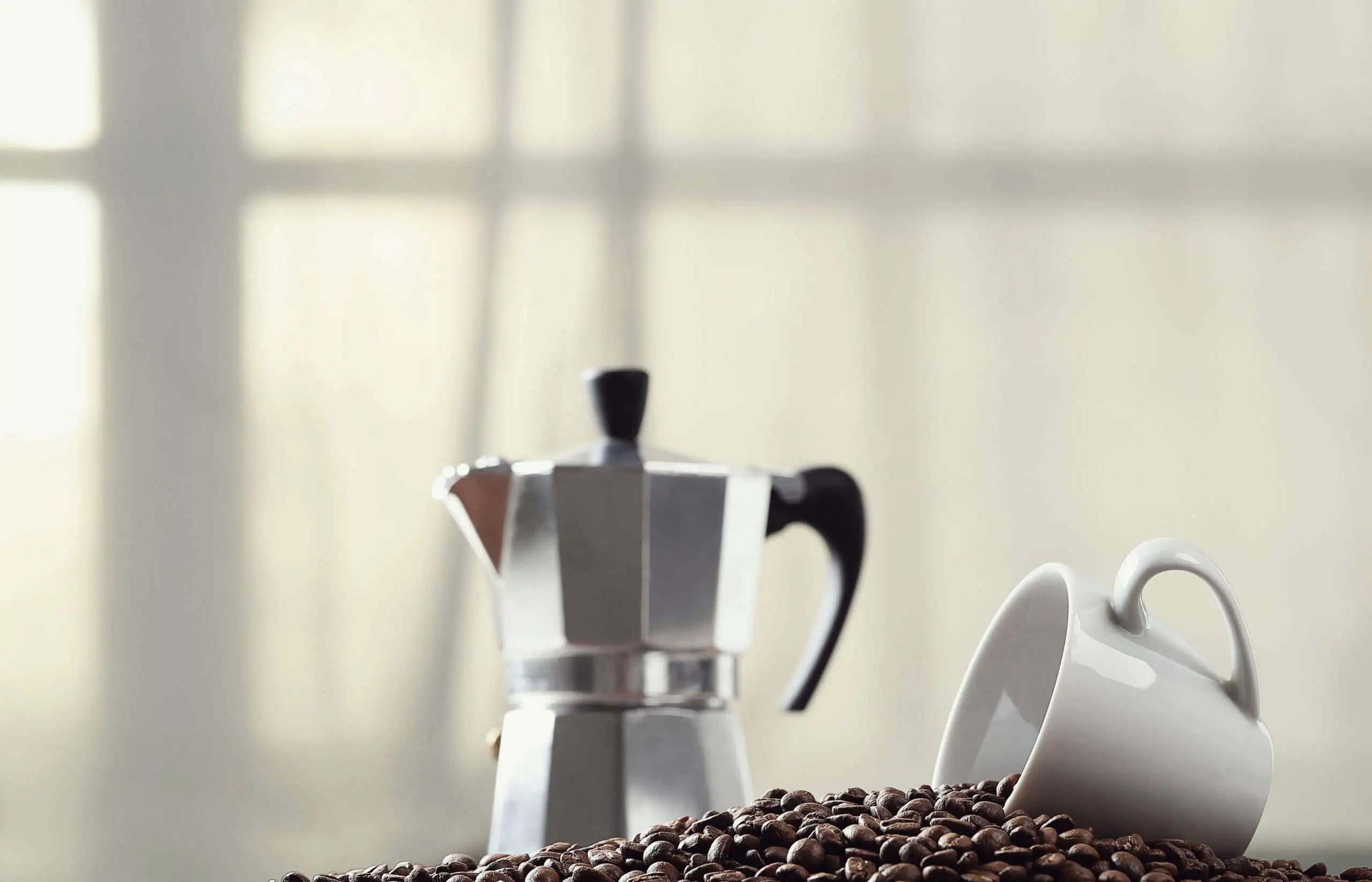 coffee pot with mug and coffee beans